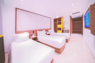 a hotel room with two beds and a projection screen at Oum Palace Hotel & Spa in Casablanca