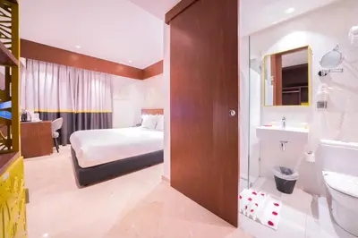 a hotel room with a bed and a bathroom at Oum Palace Hotel & Spa in Casablanca