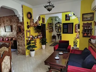 a living room with a couch and a table at Marguerite Apartemnt dans une résidence familiale in Casablanca
