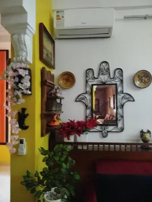 a mirror on a wall next to a fireplace at Marguerite Apartemnt dans une résidence familiale in Casablanca