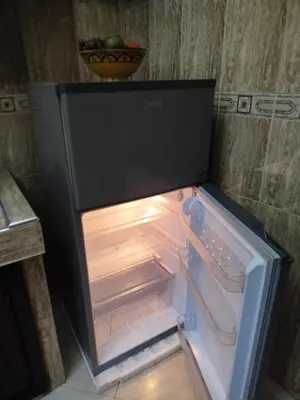 an empty refrigerator with its door open in a kitchen at Marguerite Apartemnt dans une résidence familiale in Casablanca