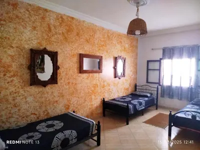 a room with two beds and two mirrors on the wall at Marguerite Apartemnt dans une résidence familiale in Casablanca