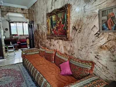 a couch with pillows sitting in a living room at Marguerite Apartemnt dans une résidence familiale in Casablanca