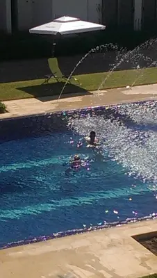 a person swimming in a swimming pool at Marbella Beach Residency in Mansouria