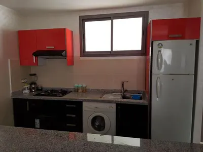 a kitchen with a white refrigerator and a washing machine at Marbella Beach Residency in Mansouria