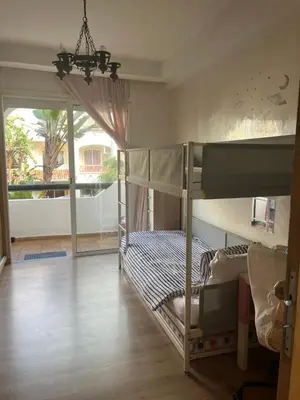 a bedroom with two bunk beds and a balcony at Appartement Casablanca Garden Beach in Casablanca