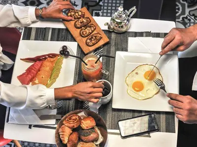 a group of people sitting around a table with breakfast foods at Ibis Casa Voyageurs in Casablanca