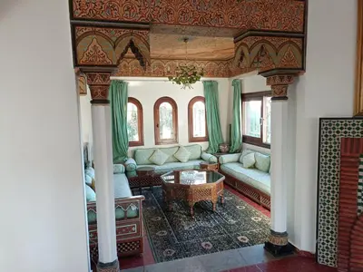 a living room with a couch and a table at Villa meublée face à la mer, Golf et Verdure in El Jadida