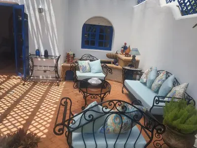 a patio with chairs and a couch and a table at Villa à Bouznika Bay-plage et golf in Bouznika