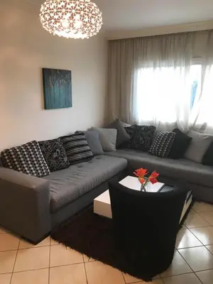 a living room with a couch and a table at Résidence les Ambassadeurs in Rabat