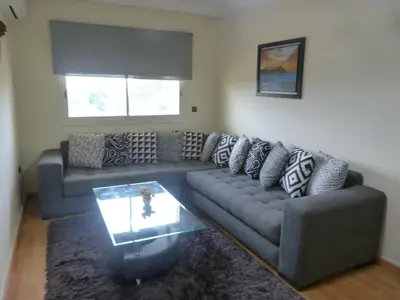 a living room with a couch and a table at Résidence les Ambassadeurs in Rabat