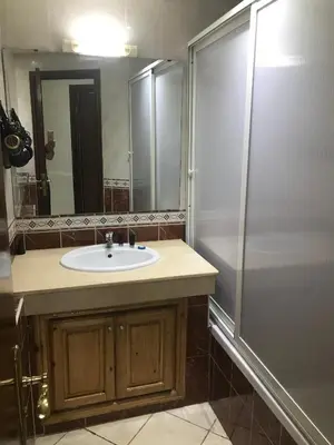 a bathroom with a sink and a shower at Résidence les Ambassadeurs in Rabat