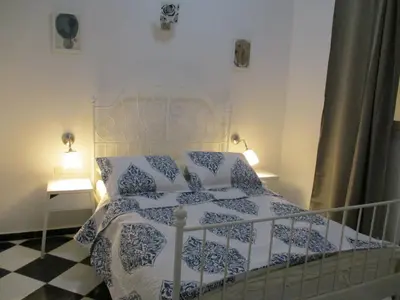 a bedroom with a white and blue bed with two lamps at appartement haussmannien centre ville Casablanca in Casablanca