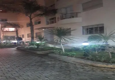 a building with palm trees in front of a street at Horizon Garden Home in Casablanca