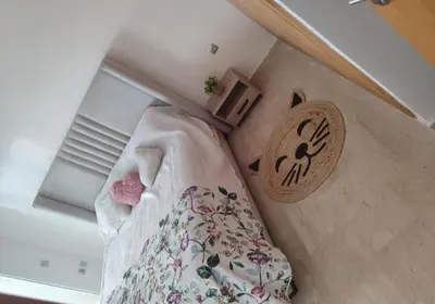 a small bedroom with a bed and a wooden box at appartments front mer in Bouznika