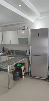 a kitchen with a refrigerator and a counter top at Ola Blanca 1 in Dar Hamida