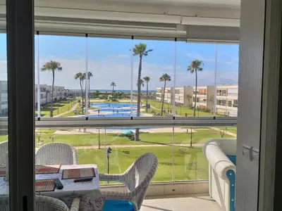 a room with a window with a view of a pool at Ola Blanca 1 in Dar Hamida
