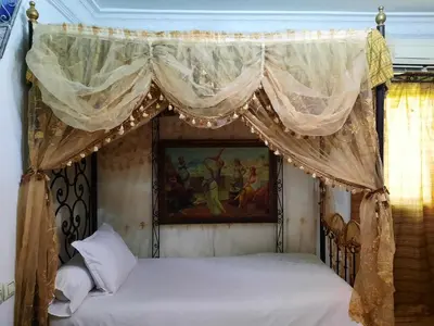 two beds in a bedroom with a canopy at Hotel Moroccan House Casablanca in Casablanca