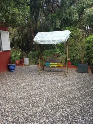 a gazebo with a covering in a garden at Location Vacances Casablanca Tamaris in Casablanca