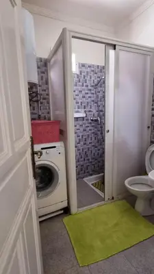 a bathroom with a washing machine and a toilet at Location Vacances Casablanca Tamaris in Casablanca