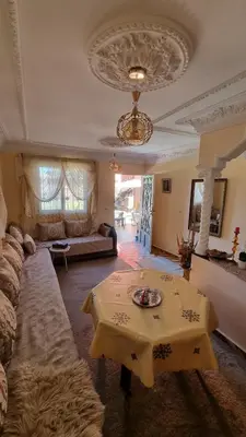 a living room with a table and a couch at Location Vacances Casablanca Tamaris in Casablanca