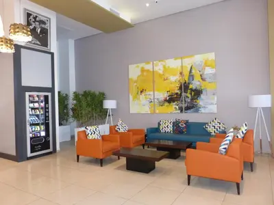 a waiting room with orange chairs and a blue couch at Relax Hotel Casa Voyageurs in Casablanca