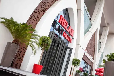 a building with a sign for a fast food restaurant at Relax Hotel Casa Voyageurs in Casablanca