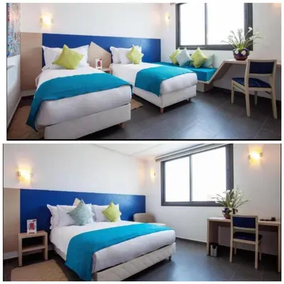 a bedroom with two beds with blue and white at Relax Hotel Casa Voyageurs in Casablanca