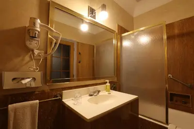 a bathroom with a sink and a mirror at Hôtel Les Saisons in Casablanca
