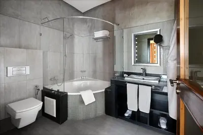 a bathroom with a tub and a toilet and a sink at Park Suites Hotel Luxury Boutique Hotel in Casablanca