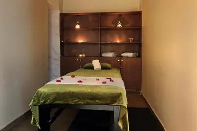 a small room with a bed with a green blanket at Park Suites Hotel Luxury Boutique Hotel in Casablanca