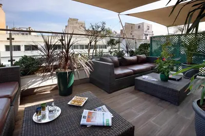 a rooftop patio with a couch and a table at Park Suites Hotel Luxury Boutique Hotel in Casablanca