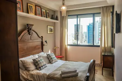 a bedroom with a bed and a large window at Appartement moderne moroccan/African décoration in Casablanca