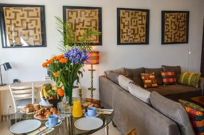a living room with a couch and a glass table at Appartement moderne moroccan/African décoration in Casablanca