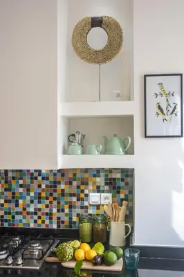 a kitchen counter with fruits and vegetables on a cutting board at Appartement moderne moroccan/African décoration in Casablanca