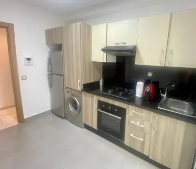a kitchen with a sink and a stove top oven at Appartement les pieds dans l'eau WELCOME STAY in Mohammedia