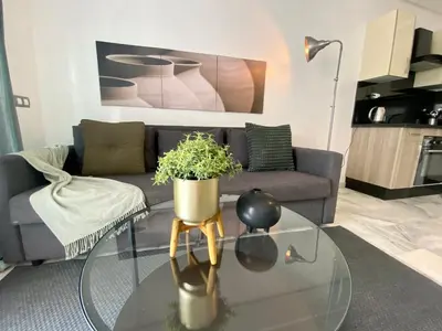 a living room with a couch and a glass table at Appartement les pieds dans l'eau WELCOME STAY in Mohammedia