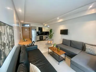 a living room with a couch and a table at Appartement les pieds dans l'eau WELCOME STAY in Mohammedia