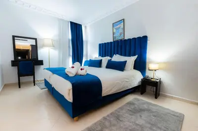 a bedroom with a bed with a stuffed animal on it at Prince de Paris in Casablanca
