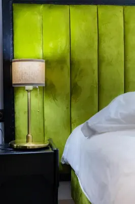 a lamp on a table next to a bed at Prince de Paris in Casablanca