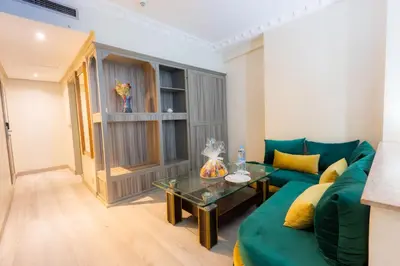 a living room with a green couch and a table at Prince de Paris in Casablanca
