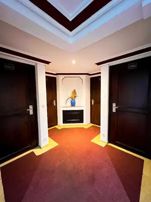 an empty hallway with two doors and a painting on the wall at Prince de Paris in Casablanca