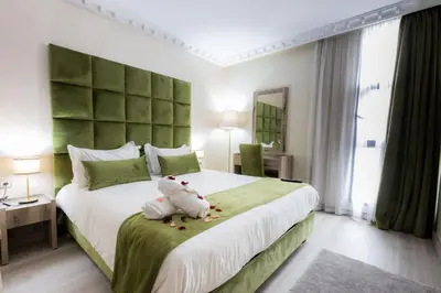 a bedroom with a bed with a teddy bear on it at Prince de Paris in Casablanca