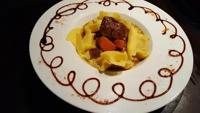 a plate of food with pasta and meat and sauce at L'échappée belle Benslimane in O Ben Slimane