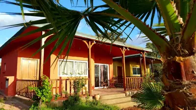 a red and yellow house with a porch at L'échappée belle Benslimane in O Ben Slimane