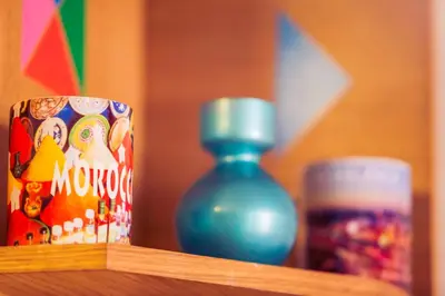 a wooden shelf with a bottle and a can of soda at Casablanca Home Stay Apartment in Casablanca