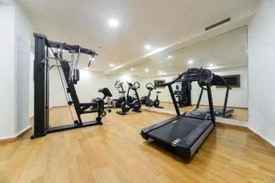 a gym with treadmills and ellipticals in a room at Golden Star Casablanca in Casablanca