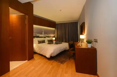 a hotel room with a bed and a desk in it at Golden Star Casablanca in Casablanca