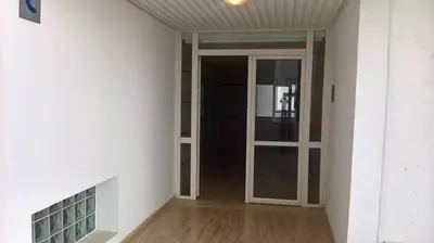 a hallway with a glass door in a room at Appartement Hay Riad in Rabat