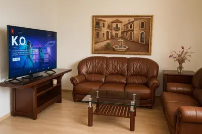 a living room with a couch and a television at Appartement Hay Riad in Rabat